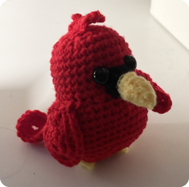A small red crocheted cardinal