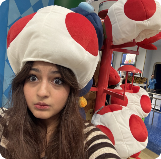 Isa wearing a Toad mushroom hat at Nintendo World